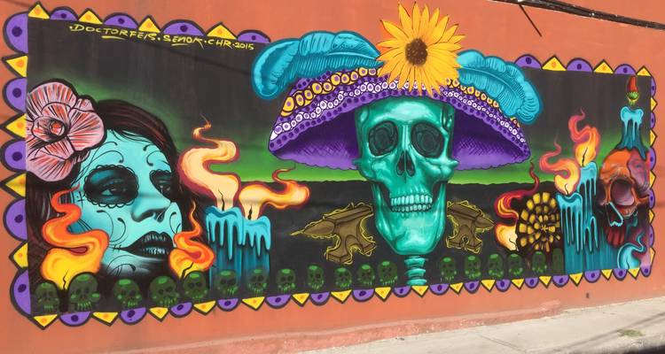 Mural colorido que representa esqueletos y arte vibrante.