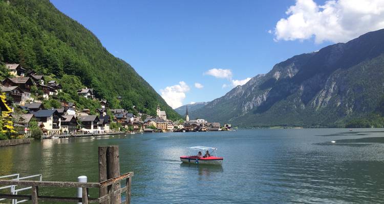 Scenic village by a lake surrounded by mountains.