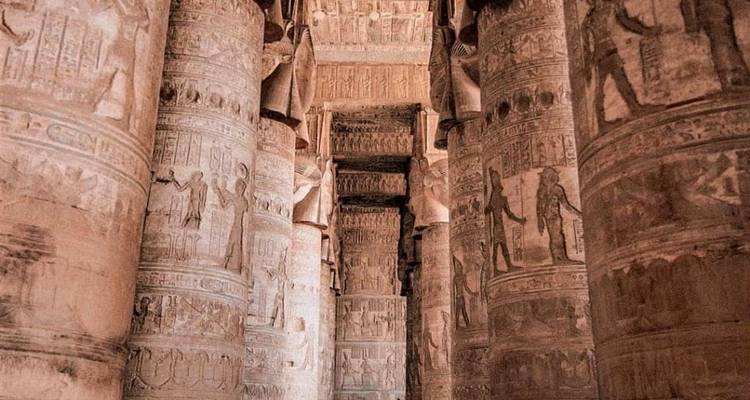 Intricately carved columns in an ancient Egyptian temple.