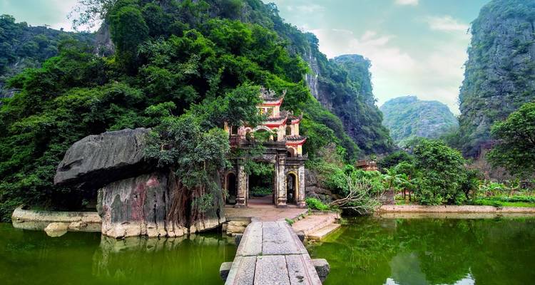 Ancient stone structure surrounded by lush green mountains.