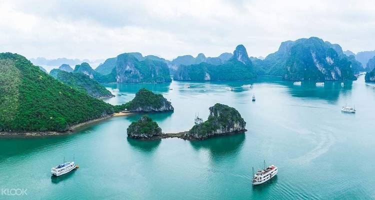 Aerial view of cruising boats among limestone islands.