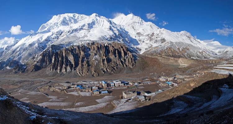Mountainous view with small settlement in the valley.