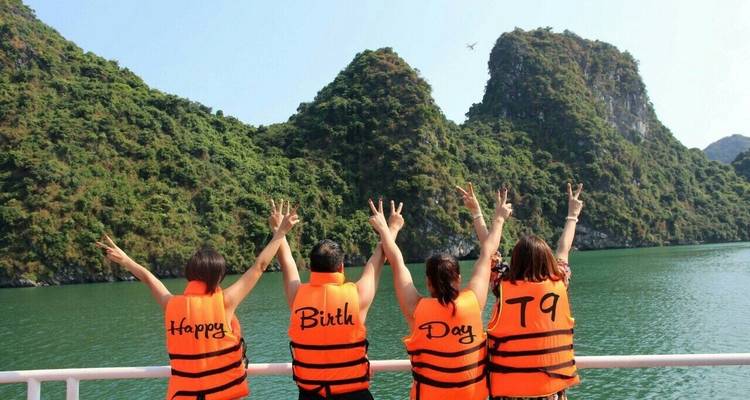 Four people on a boat wearing life jackets with text arranged to read 'Happy Bith Day'.