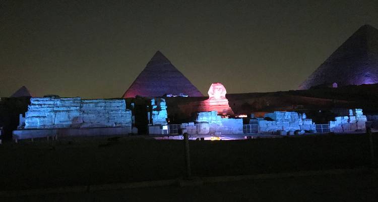 Nighttime sound-and-light show illuminating the Sphinx and the pyramids against a dark sky