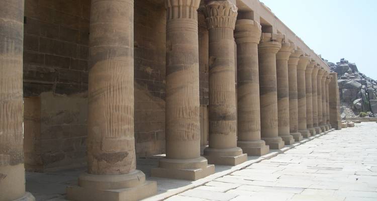 Row of ancient columns casting shadows.