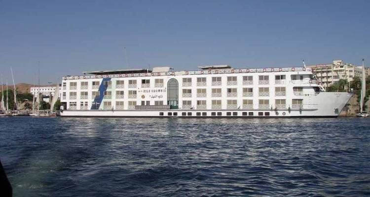 A large river cruise ship in a harbor.