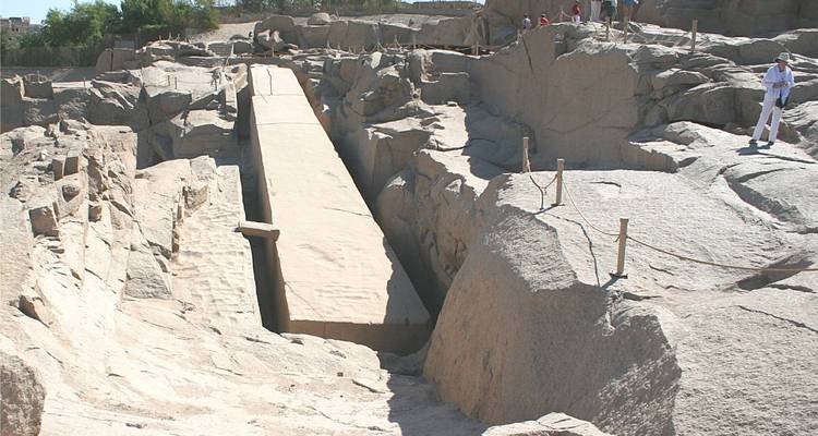 Tourists near an ancient unfinished obelisk.