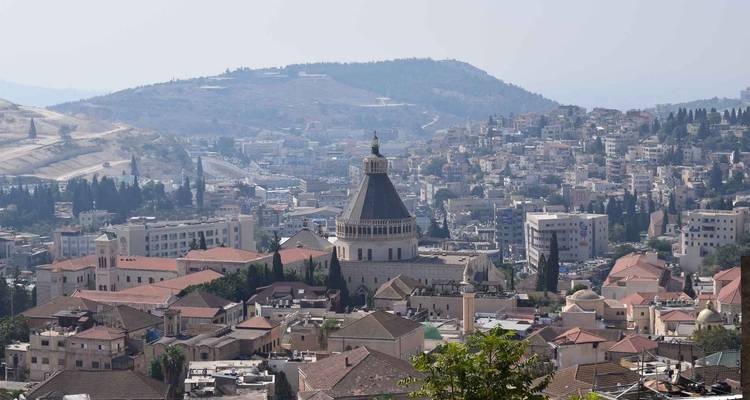 Skyline view of a city with a central religious building with a dome.