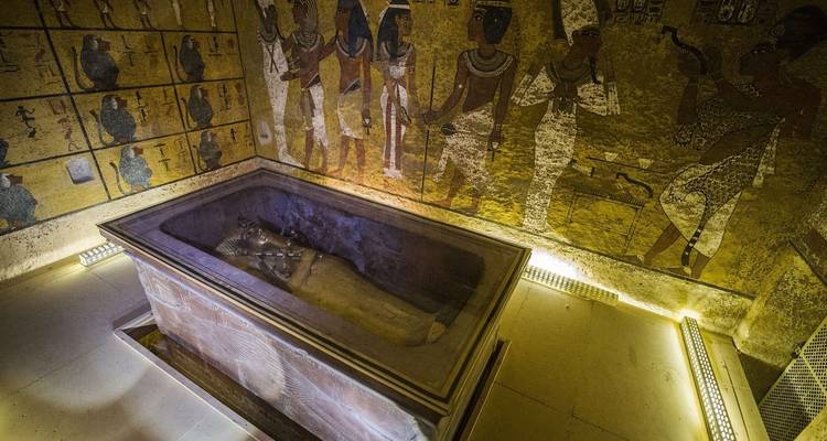 Sarcophagus inside a room with Egyptian drawings