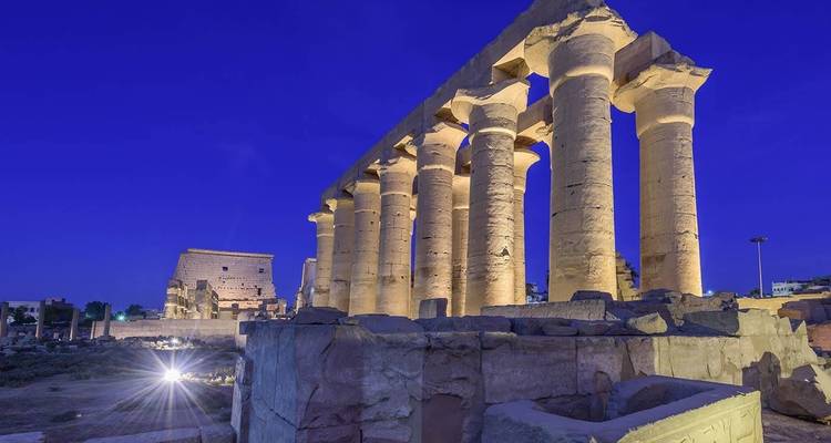 Illuminated ancient temple with columns at night