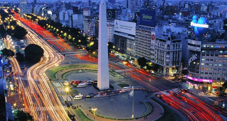 Night view of a city intersection, showcasing vibrant city lights.