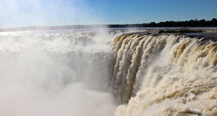 A powerful waterfall with mist rising into the air.