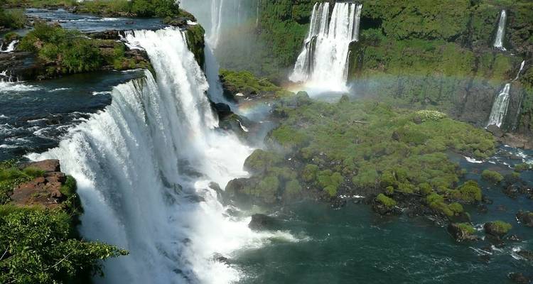 Iguazu Falls with rainbow and lush greenery.