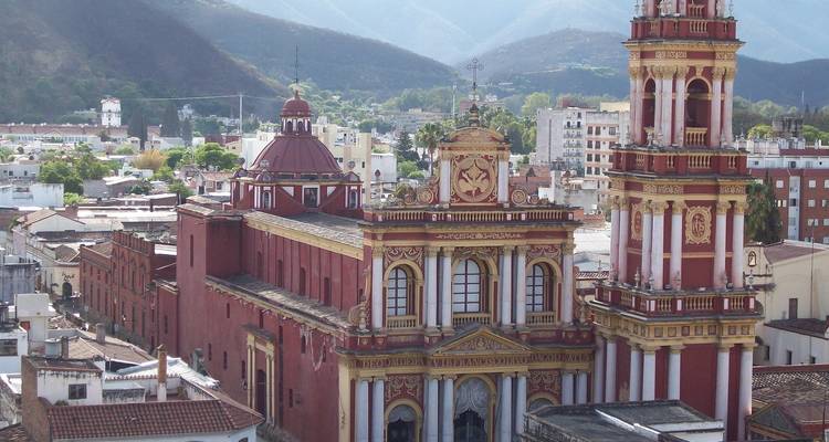 Ornate church in the city of Salta with a mountainous backdrop.