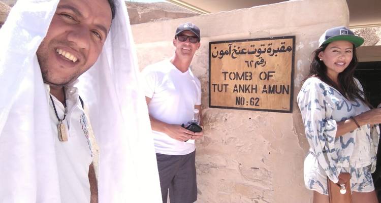 People posing by the entrance to the Tomb of Tutankhamun.