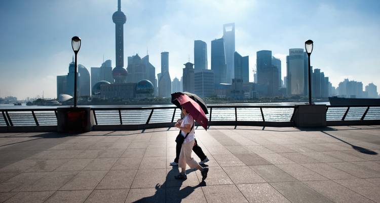 Personnes se promenant sur le Bund avec l'horizon de Shanghai.