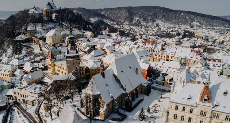 Snow-covered medieval town packed with historical buildings.