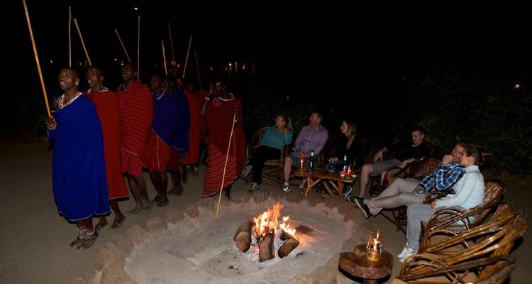 Traditional Maasai dance around a campfire at night.