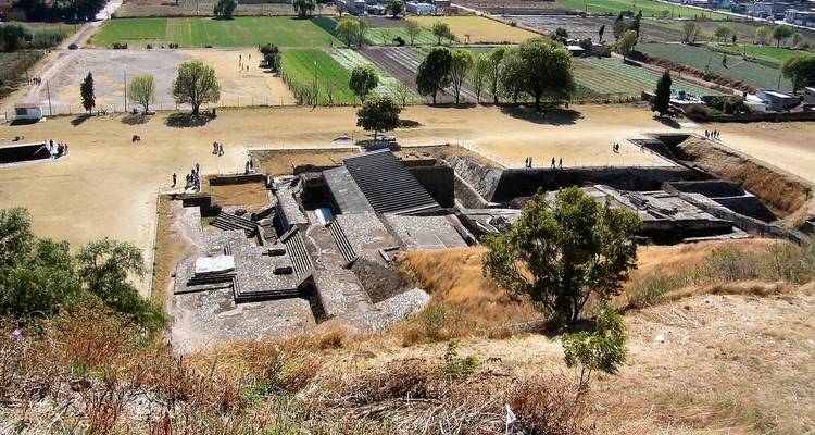 Archaeological site with ancient structures and fields.