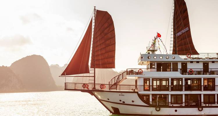 Sailing ship with red sails in Halong Bay.