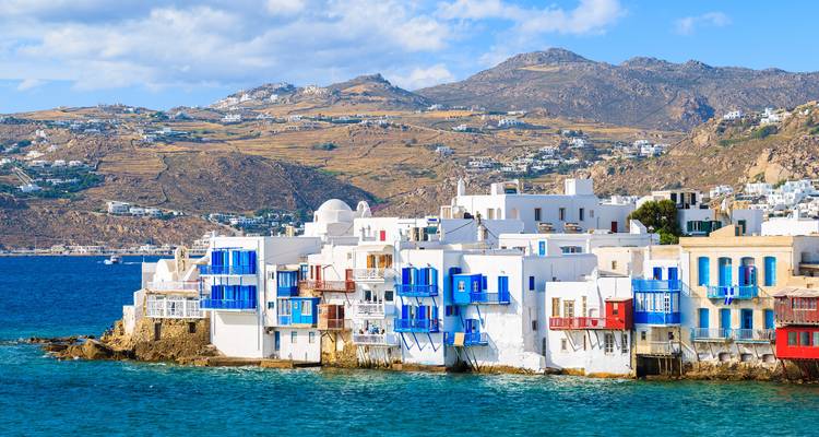 Mykonos coastline with white and blue buildings along the sea.