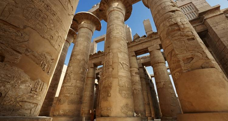 Massive stone pillars with ancient Egyptian carvings.