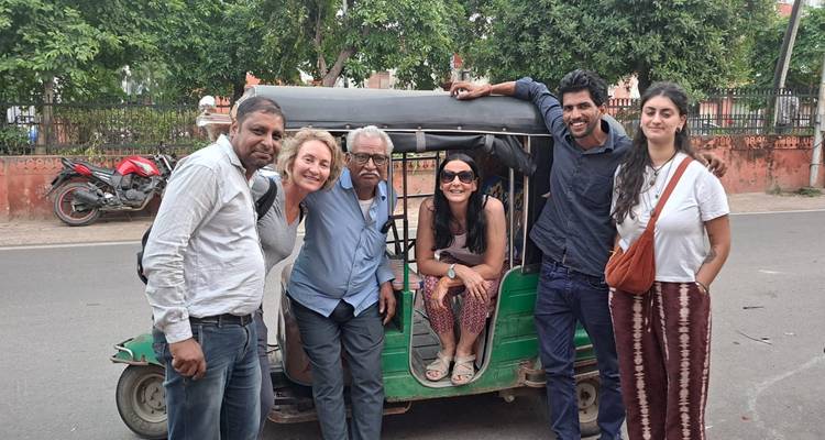 Group posing beside a tuk-tuk on a local street.