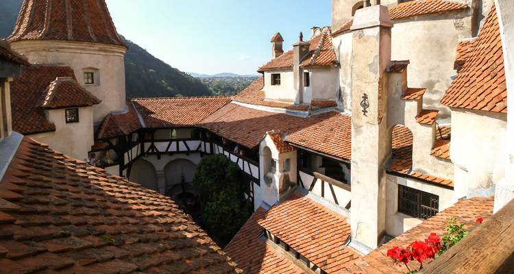 Courtyard view of a historic castle with red roofs