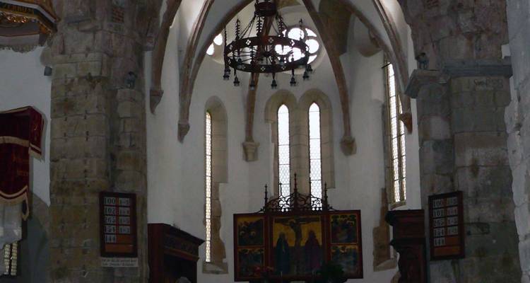 Interior of a church with arches and chandeliers