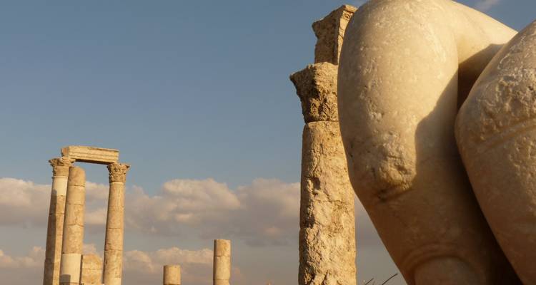 Ancient columns in archaeological site under the sky.
