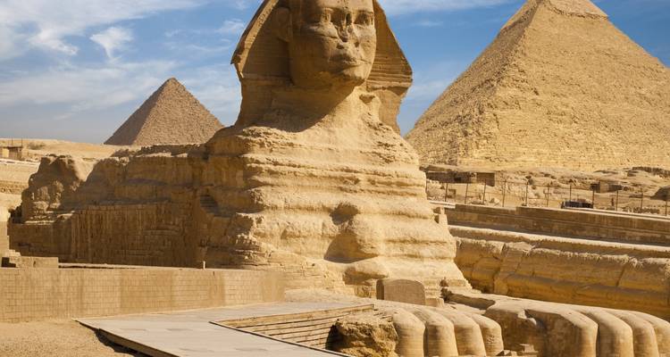 Sphinx and Pyramid of Giza under a clear blue sky.