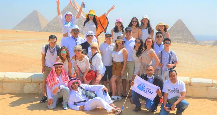 Group photo with the pyramids in the background.