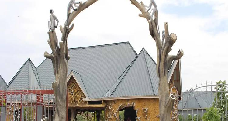 Decorative entrance with wooden carvings and rooftops.
