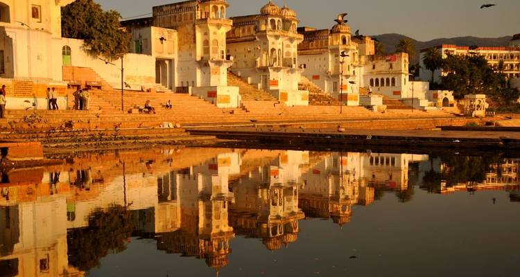 Vista panorámica del lago Pushkar con templos reflejándose en el agua.