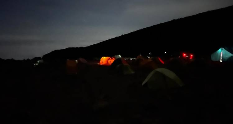 Tents illuminated in the dark.