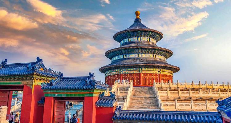 The Temple of Heaven’s Hall of Prayer glows under a dramatic sunset sky in Beijing.