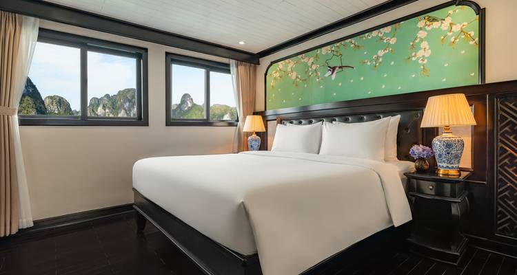 Spacious double cabin with elegant décor and bay views of jagged limestone peaks.