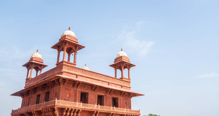 Red sandstone pavilion against a clear blue sky.