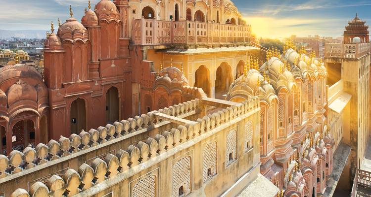 Iconic pink sandstone façades of Hawa Mahal lit by golden morning sun over Jaipur