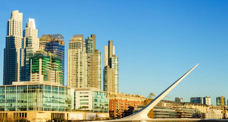 Modern skyline with high-rise buildings and a distinctive bridge.