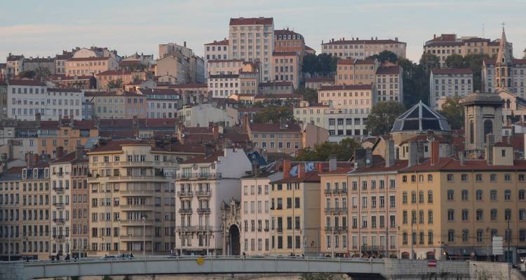 Panorama of Lyon’s varied hillside apartment buildings stacked above the riverfront.