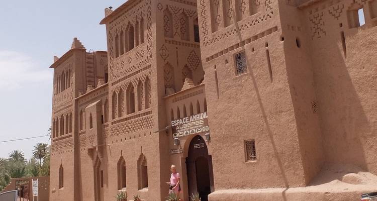 Ancient building with intricate designs and a person at the entrance.
