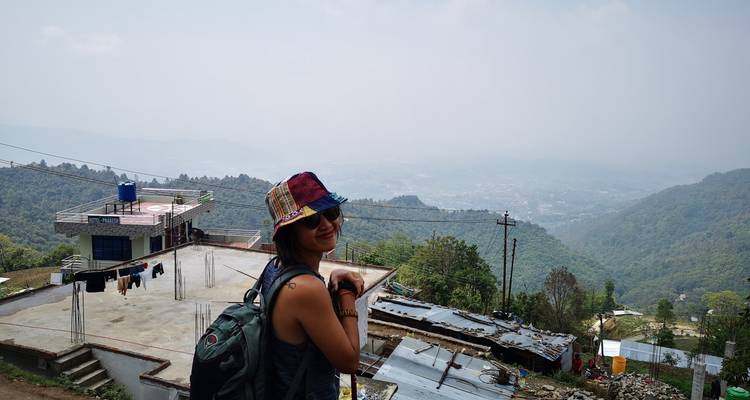 Woman with backpack overlooking a rural landscape