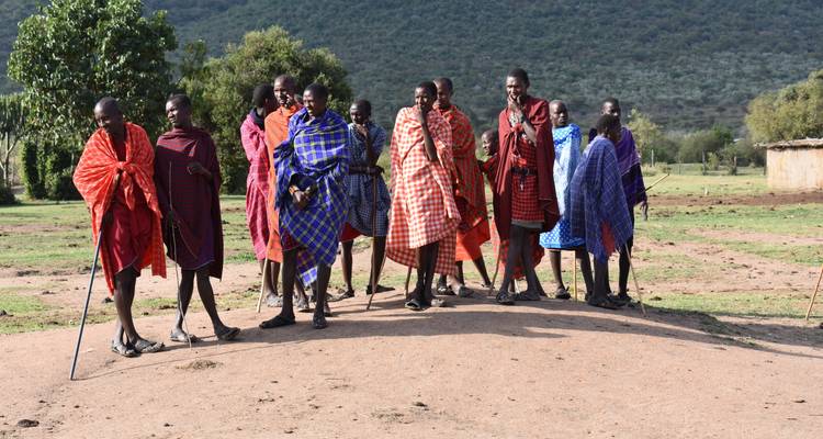 Group of Maasai people walking in traditional clothing.