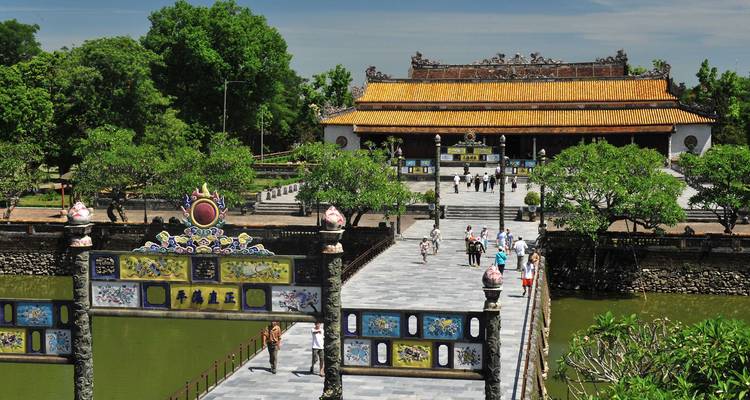 Visitors walking towards a beautifully decorated temple.