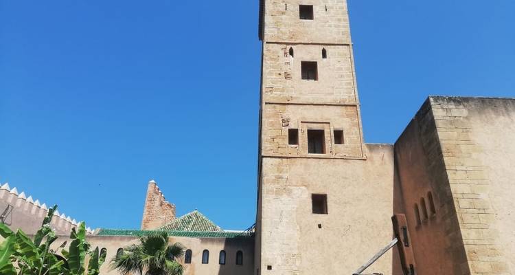 A historic tower set against a vivid blue sky.