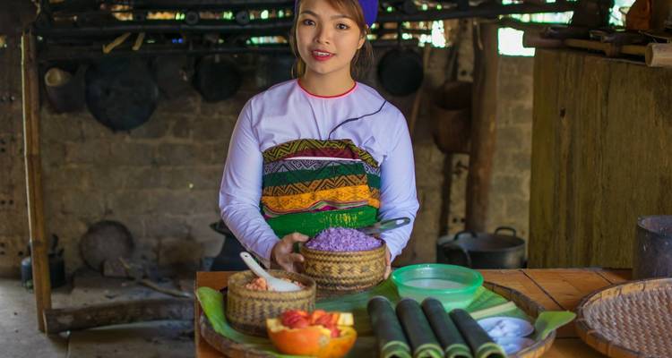 Person showcasing traditional food preparation.