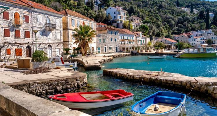 Quaint harbor with boats and colorful buildings.
