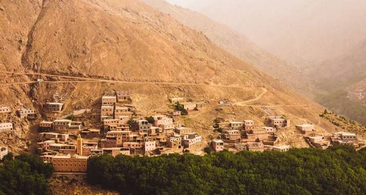 Ein Dorf, das sich an die Hänge eines kahlen Berges schmiegt.