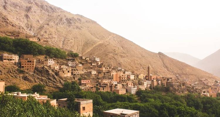 A village with traditional buildings nestled in a rocky landscape.